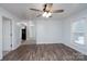 Light-filled living room with neutral walls, wood-look flooring, and a ceiling fan at 28419 Nc Hwy 73 Hwy, Albemarle, NC 28001