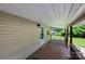 Relaxing covered porch featuring a wood floor, white siding, and a welcoming ambiance at 28419 Nc Hwy 73 Hwy, Albemarle, NC 28001