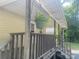 A cozy porch featuring a hanging flower basket and wooden railings, inviting you to relax and enjoy the outdoors at 28419 Nc Hwy 73 Hwy, Albemarle, NC 28001