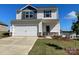 Charming two-story home featuring a two-car garage, stone accents, and manicured lawn at 3358 Burberry Dr, Gastonia, NC 28052