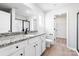 Bathroom featuring a granite countertop, a large mirror, wood floors, and a shower with black trim at 3422 Saddlebred Dr, Gastonia, NC 28052