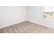 Empty bedroom featuring neutral carpet, a window with blinds, and two electrical outlets at 3422 Saddlebred Dr, Gastonia, NC 28052