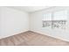 Empty bedroom featuring neutral carpet, a window with blinds, and an electrical outlet at 3422 Saddlebred Dr, Gastonia, NC 28052