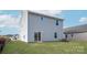 Spacious backyard with lush green grass, a sliding glass door, and a view of the surrounding neighborhood at 3430 Saddlebred Dr, Gastonia, NC 28052