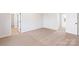Bedroom with neutral carpet and white walls leading to bathroom and closet entrances at 3430 Saddlebred Dr, Gastonia, NC 28052