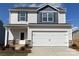 Two-story home featuring vinyl siding, a garage, and a covered front porch with stone accents at 3430 Saddlebred Dr, Gastonia, NC 28052