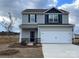 Charming two-story home featuring a two-car garage, stone accents, and a well-manicured front lawn at 3430 Saddlebred Dr, Gastonia, NC 28052
