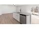 Kitchen island features a stainless steel dishwasher, granite countertops, and a view of the backyard at 3430 Saddlebred Dr, Gastonia, NC 28052