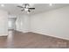 Bright and airy living room with a ceiling fan, laminate flooring, and ample natural light at 3430 Saddlebred Dr, Gastonia, NC 28052