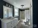 Bathroom with classic vanity, white fixtures, and shower with bathtub combo at 3481 Roberta Rd, Concord, NC 28027