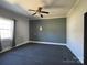 Bedroom with neutral walls and ceiling fan, offering ample space for furniture at 3481 Roberta Rd, Concord, NC 28027