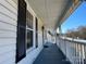 Inviting front porch offers a relaxing space with classic white railing and blue flooring at 3481 Roberta Rd, Concord, NC 28027