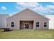 A spacious backyard featuring a covered patio and well-maintained lawn, perfect for outdoor enjoyment at 3527 Clover Valley Dr, Gastonia, NC 28052