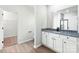 Bathroom vanity with granite countertop, white cabinets, and a large mirror at 3527 Clover Valley Dr, Gastonia, NC 28052