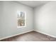 Bright bedroom featuring hardwood floors and a large window at 3527 Clover Valley Dr, Gastonia, NC 28052