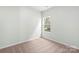 Bedroom with neutral carpet and a window with a natural view at 3527 Clover Valley Dr, Gastonia, NC 28052
