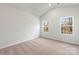 Bedroom with neutral carpet, vaulted ceiling, and two large windows at 3527 Clover Valley Dr, Gastonia, NC 28052