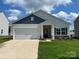 Charming single-story home with a two-car garage, covered entrance, and manicured lawn at 3527 Clover Valley Dr, Gastonia, NC 28052