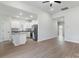 Open-concept living space showcasing wood-look flooring, neutral walls, and kitchen with stainless steel appliances at 3527 Clover Valley Dr, Gastonia, NC 28052