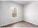 Bright bedroom featuring wood-look floors and natural light from a single window at 3606 Clover Valley Dr, Gastonia, NC 28052