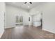 Bright and airy living room area featuring wood-look flooring, a sliding glass door to the outside, and an open kitchen at 3606 Clover Valley Dr, Gastonia, NC 28052