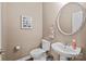 Stylish half bath featuring a decorative mirror, modern sink, and framed art at 437 Buttermere Rd # 31, Fort Mill, SC 29715