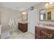 Bathroom featuring double vanities with granite countertops, framed mirrors, neutral paint, and tile floors at 437 Buttermere Rd # 31, Fort Mill, SC 29715