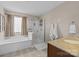 Bright bathroom featuring a glass shower, soaking tub, neutral walls, and patterned towels at 437 Buttermere Rd # 31, Fort Mill, SC 29715
