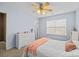 Bedroom featuring blue accent walls, white furnishings, a ceiling fan, and natural light at 437 Buttermere Rd # 31, Fort Mill, SC 29715