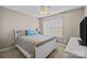 Charming bedroom featuring beige walls, white trim, a ceiling fan, and natural light at 437 Buttermere Rd # 31, Fort Mill, SC 29715