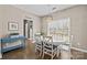 Bright dining room features an oval table, white chairs, and natural light from a large window at 437 Buttermere Rd # 31, Fort Mill, SC 29715
