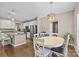 Elegant dining area showcases an open layout, with a view of the kitchen and a modern chandelier at 437 Buttermere Rd # 31, Fort Mill, SC 29715