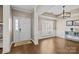 Elegant dining room featuring hardwood floors, wainscoting, tray ceilings, and natural light from a window at 437 Buttermere Rd # 31, Fort Mill, SC 29715