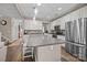 Modern kitchen boasts white cabinetry, stainless steel appliances, and a large island with seating at 437 Buttermere Rd # 31, Fort Mill, SC 29715