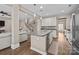 Modern kitchen with white cabinetry, stainless steel appliances, and an island with bar seating at 437 Buttermere Rd # 31, Fort Mill, SC 29715