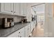 Eat-in kitchen with white cabinets, gray countertops, and stainless steel appliances provides seamless flow at 437 Buttermere Rd # 31, Fort Mill, SC 29715