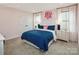 Charming bedroom featuring a large bed with stylish blue polka dot bedding and a decorative monogram above the headboard at 496 Kenyon Dr, Denver, NC 28037