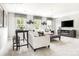 Cozy living room showcasing modern decor, comfortable seating, and ample natural light from the three windows at 496 Kenyon Dr, Denver, NC 28037