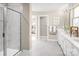 Bathroom with tiled shower, white cabinets and double vanity at 497 Kenyon Dr, Denver, NC 28037