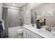 Well-lit bathroom with a double vanity, featuring modern fixtures, neutral tones, and a tiled shower-tub combination at 497 Kenyon Dr, Denver, NC 28037