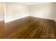 Spacious room featuring hardwood floors, fresh paint and neutral interior design at 5014 Coronado Dr, Charlotte, NC 28212