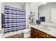 Bathroom featuring a shower with blue striped curtain, vanity, and mirrored wall shelf at 5252 Admirals Lndg, Lancaster, SC 29720