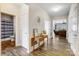 Welcoming foyer with wood floors, decorative table, and view into the living room at 5252 Admirals Lndg, Lancaster, SC 29720