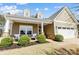 Inviting front porch featuring seating, manicured bushes, and stone accents at 5252 Admirals Lndg, Lancaster, SC 29720