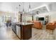 Open-concept kitchen and living room featuring a large island and leather couches at 5252 Admirals Lndg, Lancaster, SC 29720