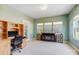 Open-concept sitting room with desk, faux fireplace, and a wall of windows for natural light at 5252 Admirals Lndg, Lancaster, SC 29720