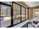 Sunroom with wall-to-wall windows overlooking the wooded backyard at 5252 Admirals Lndg, Lancaster, SC 29720