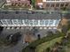 Aerial shot of townhomes with well-maintained landscaping, parking area, and close to green space at 530 N Mcdowell St, Charlotte, NC 28204