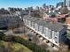 Townhome community with a cityscape view, showing modern townhomes, landscaping, and street parking at 530 N Mcdowell St, Charlotte, NC 28204