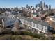 Aerial view showcasing modern townhomes with garages in front of the beautiful city skyline at 530 N Mcdowell St, Charlotte, NC 28204